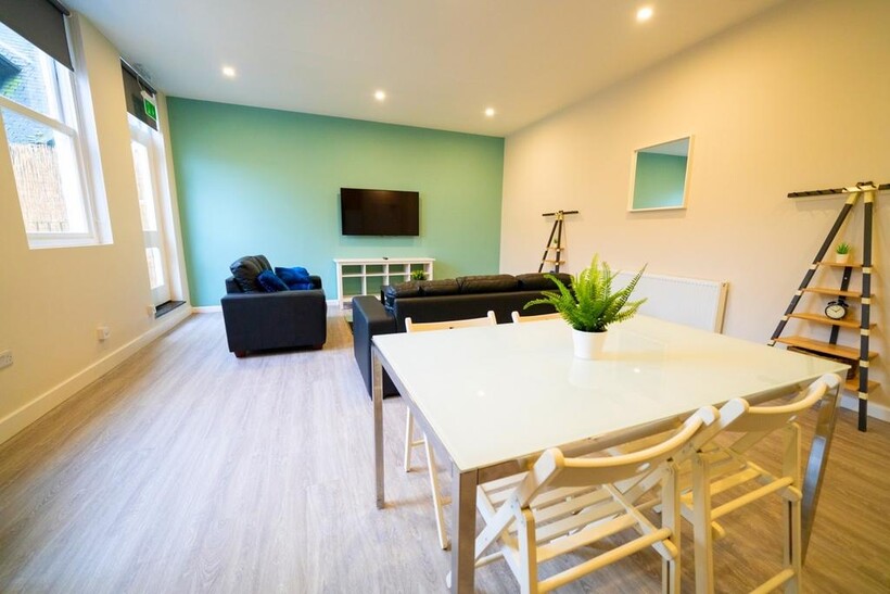 Bright and modern living room featuring a comfo...