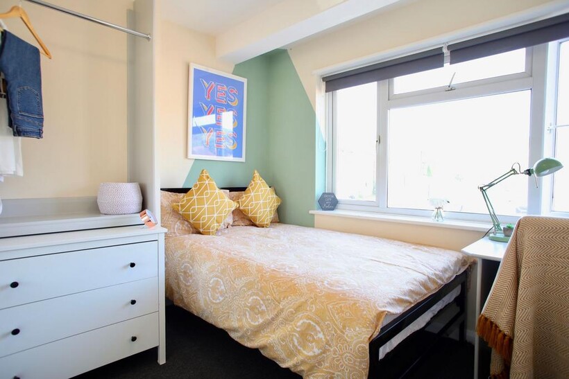 Bright and cozy double bedroom featuring a comf...