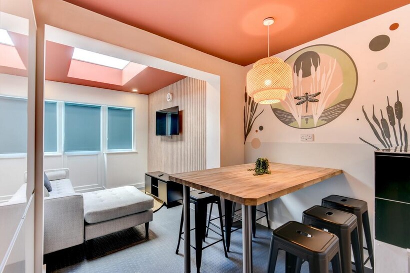 Bright, modern living area with a cosy chaise s...