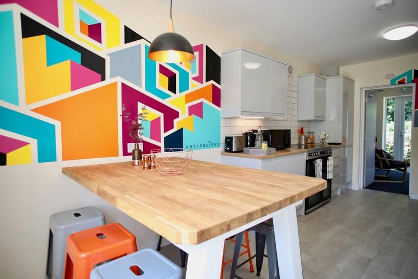 Bright modern kitchen with a large wooden break...