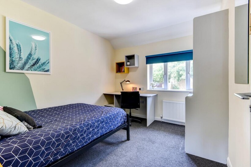 Bright and tidy bedroom featuring a single bed ...