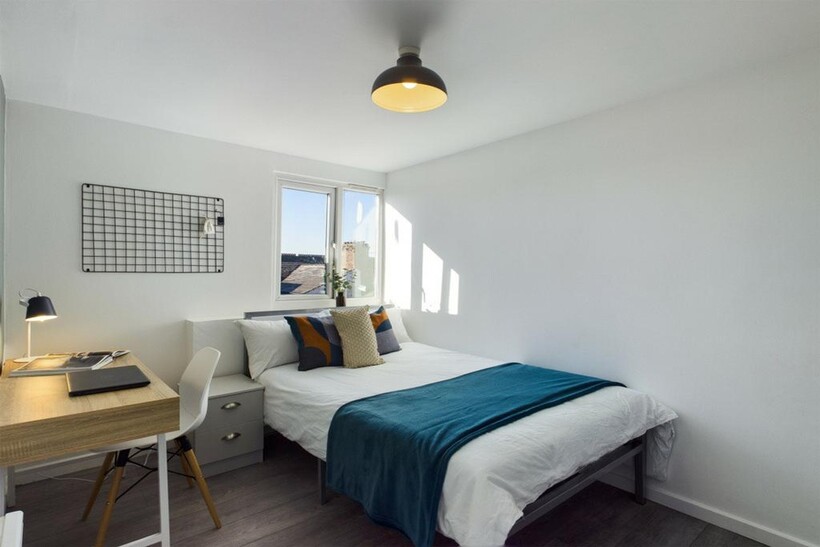 A bright and inviting double bedroom with moder...