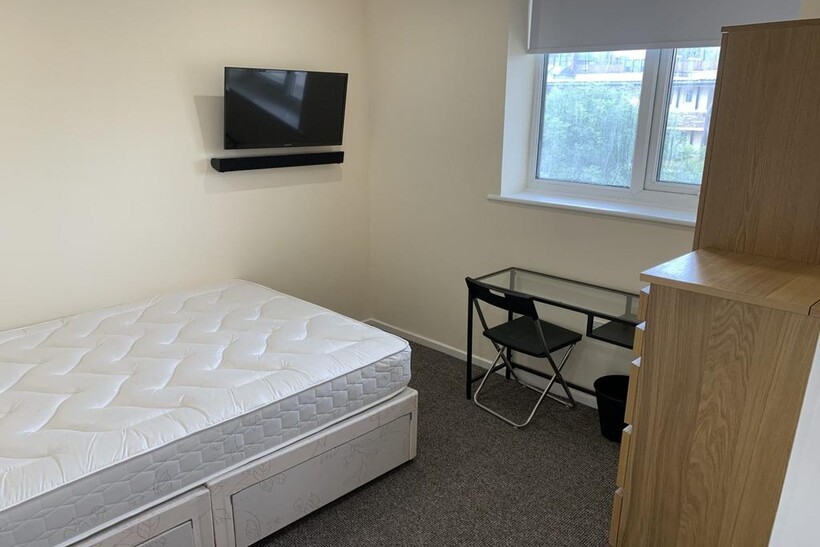 A bright and inviting double bedroom featuring ...